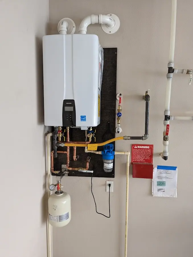 Professional plumber installing copper piping in a Allegan home